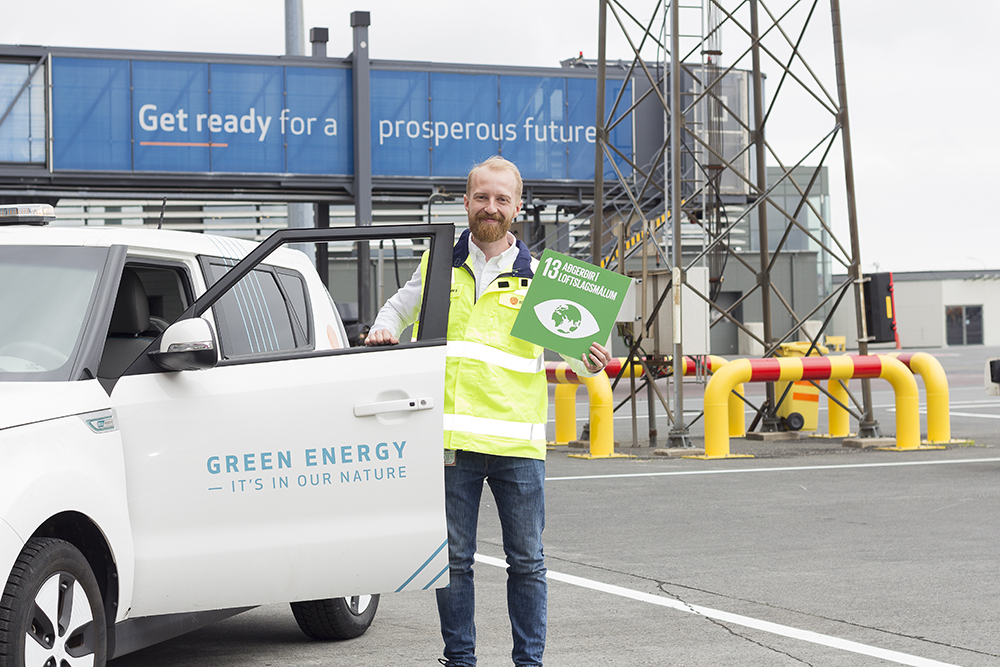 Employee holding a sign encouraging climate action